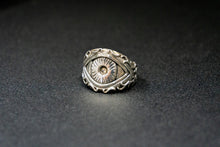 Load image into Gallery viewer, front three quarter view of a sterling silver ring of the eye of polyphemus the legendary greek cyclops on black table