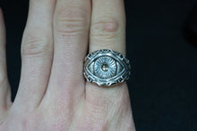 Load image into Gallery viewer, front on shot of a sterling silver ring of the eye of polyphemus the greek cyclops myth on finger