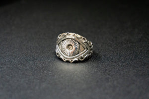 front three quarter view of a sterling silver ring of the eye of polyphemus the legendary greek cyclops on black table