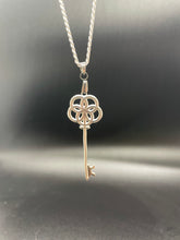 Load image into Gallery viewer, a skeleton key pendant based on greek god portunus with egg of life design on handle hanging from sterling silver chain
