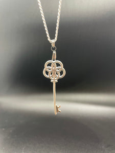 a skeleton key pendant based on greek god portunus with egg of life design on handle hanging from sterling silver chain