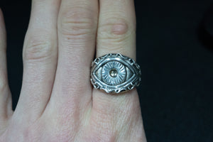 front on shot of a sterling silver ring of the eye of polyphemus the greek cyclops myth on finger