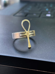 sterling silver ankh ring on a laptop. close up