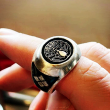 Load image into Gallery viewer, sterling silver japanese kamon ring with triforce designs on side on a finger.
